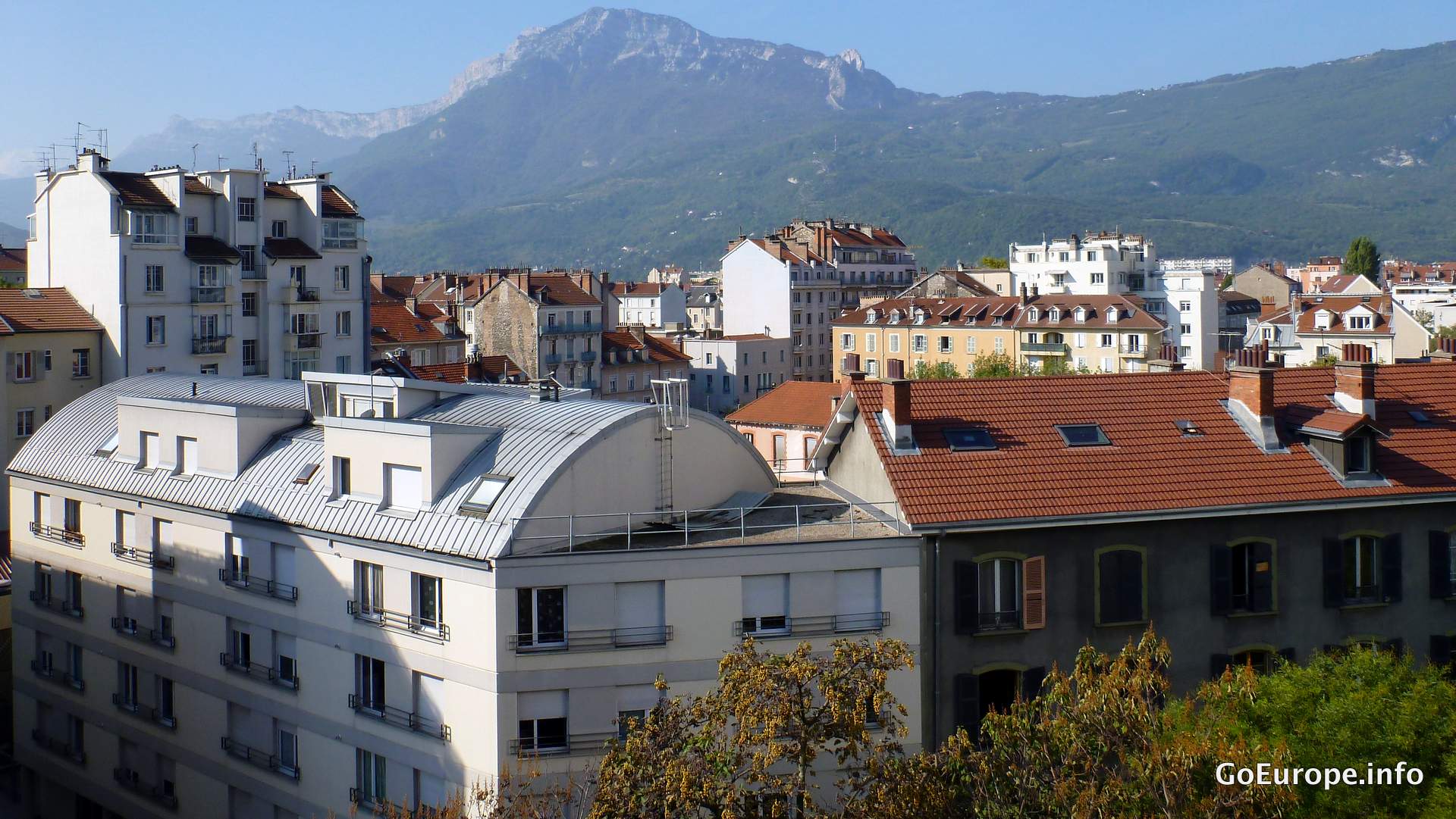 Grenoble spread across the valley with mountains rising behind it.